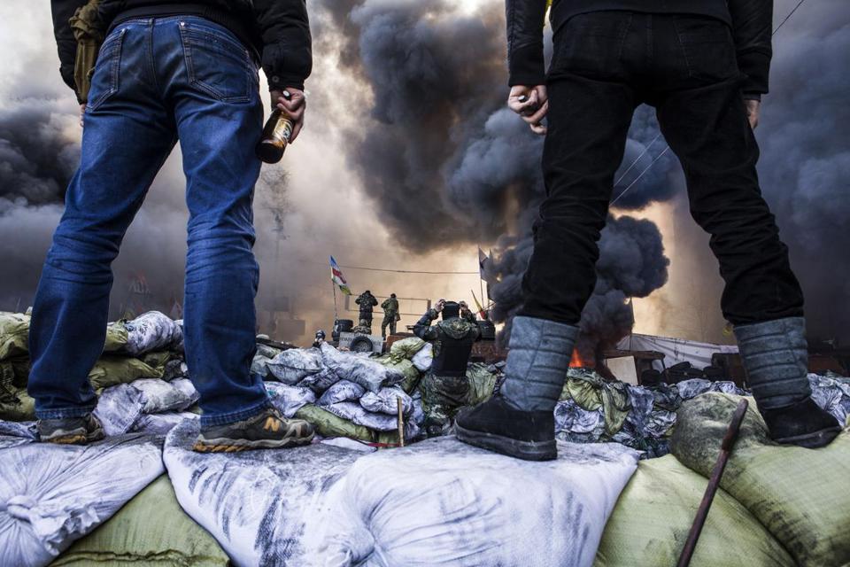 Demonstrators stood on barricades during clashes Feb. 18 with riot police in Kiev.