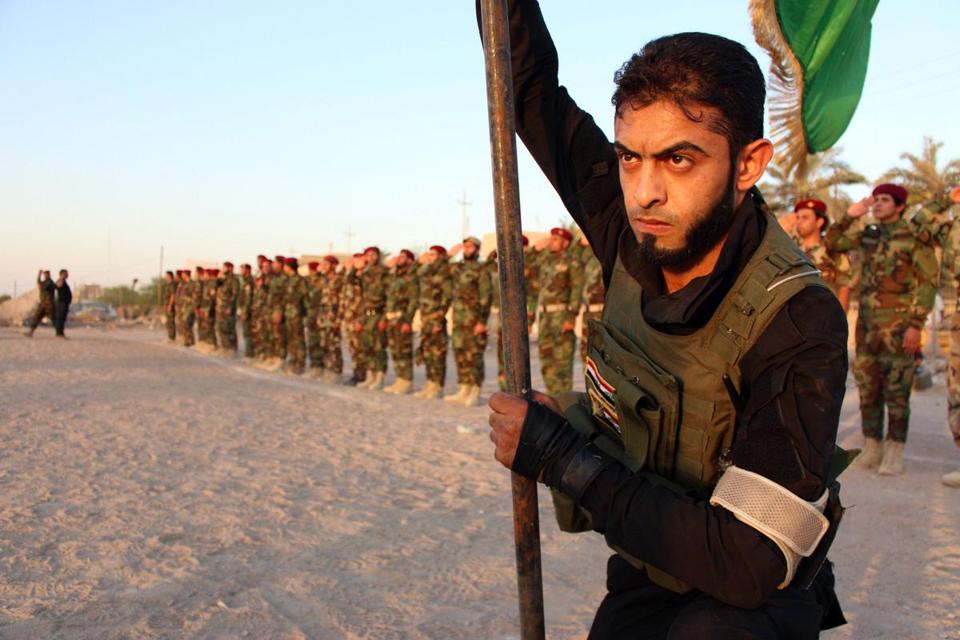 Shiite militia members train in Iraq Tuesday, after Sunni extremists overran key cities. (AFP/GETTY IMAGES)