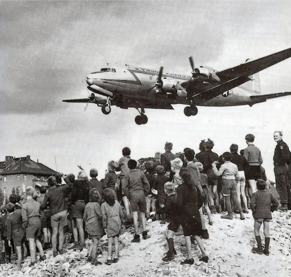 A US Air Force C-54 Skymaster bringing supplies to blockaded Berliners in 1948 approaches Berlin’s Templehof Air Base.