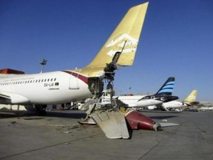 Damaged aircraft is seen at Tripoli International Airport after unidentified war planes attacked targets in the Libyan capital in August. - REUTERS