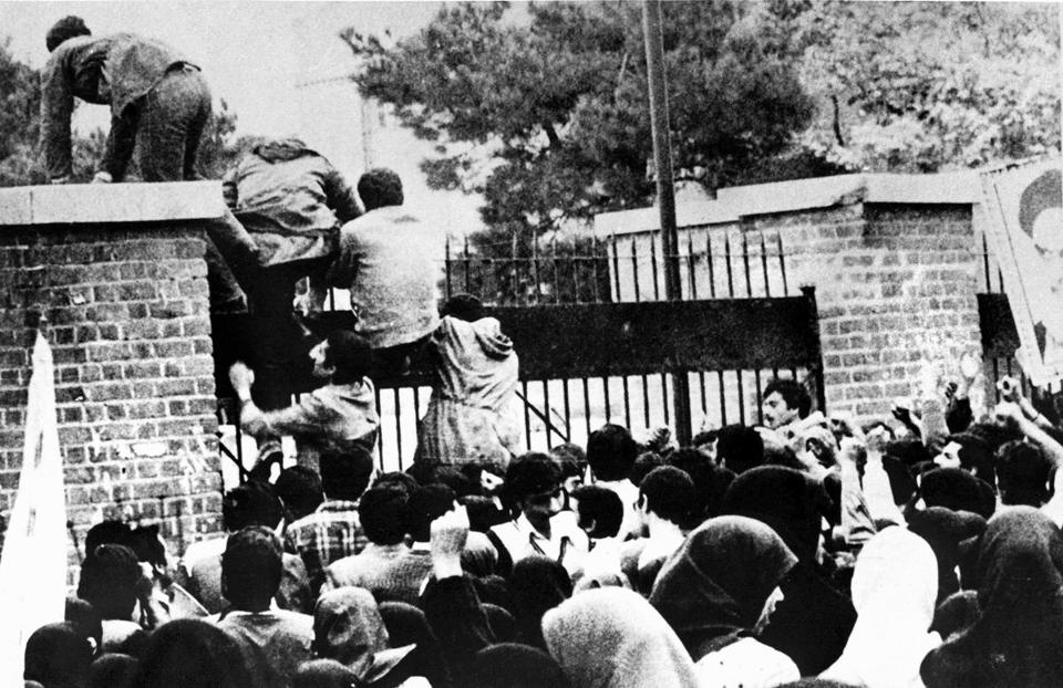 Iranian students climbed over the wall of the US embassy in Tehran on Nov. 4, 1979. - AFP/GETTY IMAGES