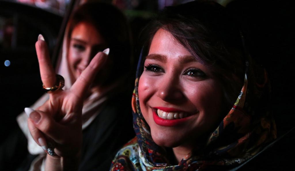 Iranian women flash the 'V' sign for victory during celebrations in northern Tehran on July 14, 2015, after Iran's nuclear negotiating team struck a deal with world powers in Vienna. (AFP/Getty Images)
