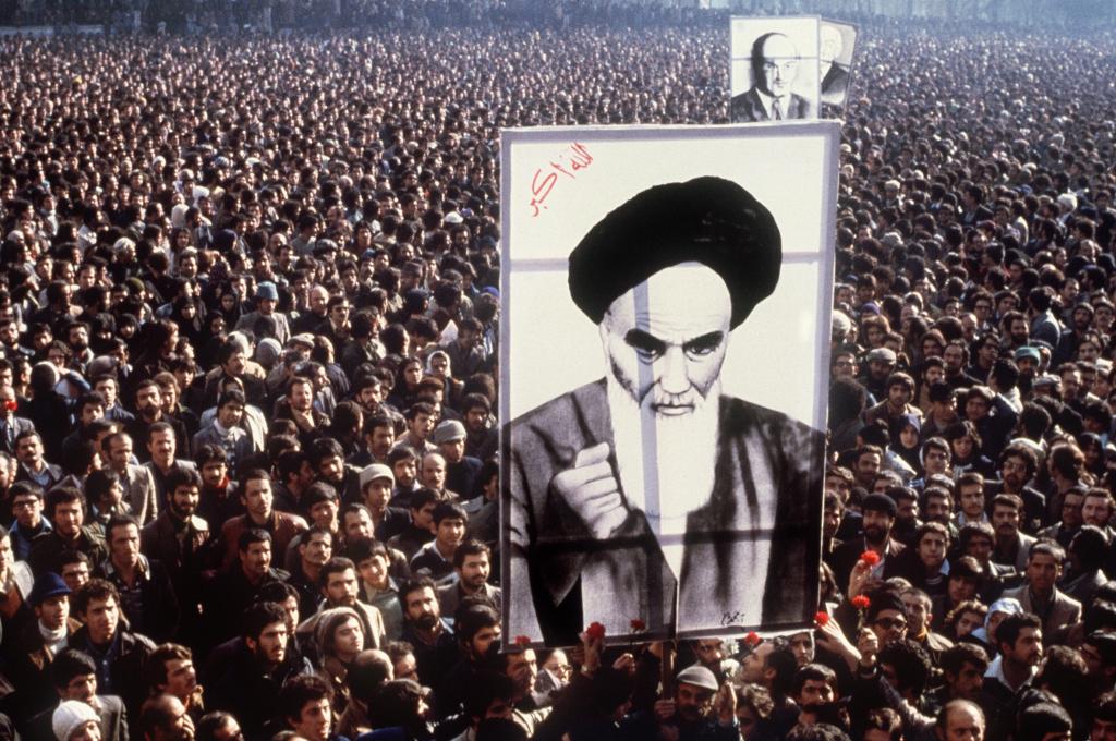 In a file picture taken in January 1979, Iranian protesters hold up a poster of Ayatollah Ruhollah Khomeini during a demonstration in Tehran against the Shah. Weeks later, the US-backed leader was toppled. Months later, the Islamic Revolution in Iran was complete. (AFP/Getty Images)