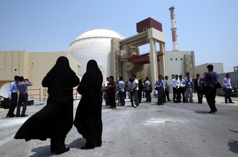 Iranian security officials looked at members of the media in front of the Bushehr nuclear plant. - EPA/FILE 2010