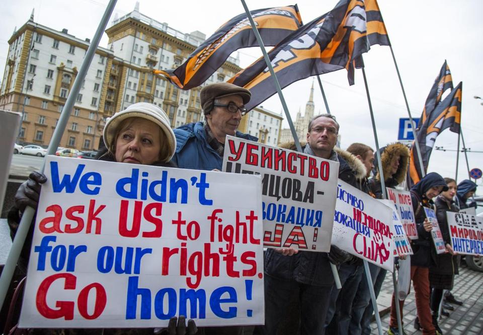 Protesters held anti-American posters during a demonstration in March in front of the US embassy in Moscow. - AP