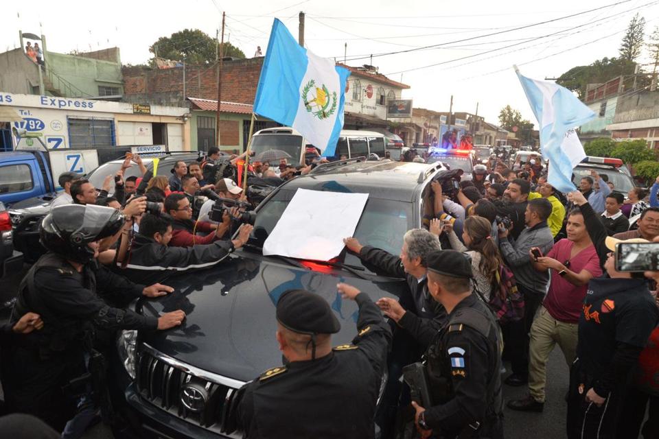 Demonstrators surrounded the vehicle carrying former President Otto Perez Molina as he arrived at the Matamoros military barracks in Guatemala City on Thursday. A judge ordered him to jail hours after the politician had resigned from the presidency amid a massive corruption scandal.  - AFP/GETTY IMAGES
