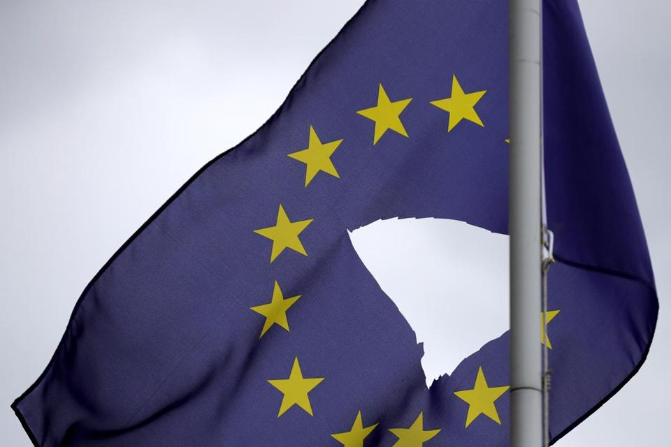 A European Union flag, with a hole cut in the middle, flies at half mast in Knutsford, England. - CHRISTOPHER FURLONG/GETTY IMAGES